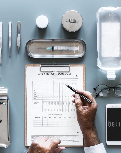 Doctor writing patient daily report exmaination